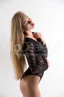 Sensual beautiful woman posing in black bodysuit