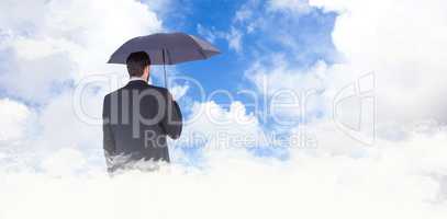 Composite image of businesswoman in suit holding umbrella