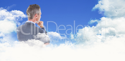 Composite image of businessman thinking