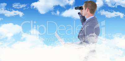 Composite image of businessman using binoculars