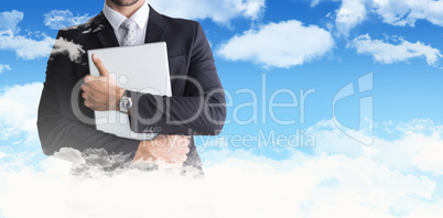 Composite image of mid section of businessman holding computer