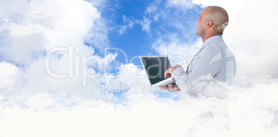Composite image of businessman using laptop Composite image of businessman using laptop