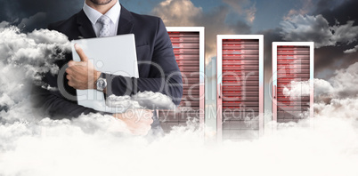 Composite image of mid section of businessman holding computer