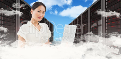 Composite image of asian businesswoman using laptop