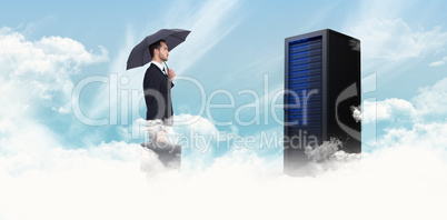 Composite image of businessman under umbrella while holding a br