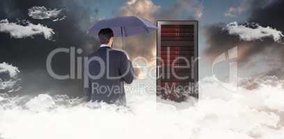 Composite image of businesswoman in suit holding umbrella