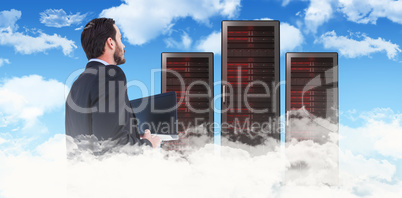 Composite image of businessman in suit holding laptop Composite image of businessman in suit holding laptop