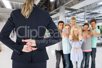 Composite image of rear view of businesswoman with fingers cross