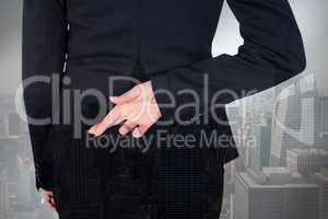 Composite image of businesswoman with fingers crossed behind her