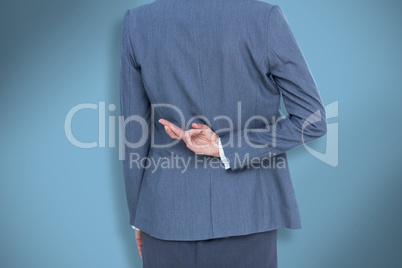 Composite image of businesswoman with fingers crossed behind her