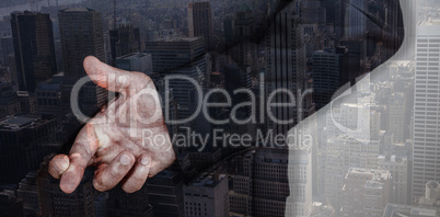 Composite image of businessman with fingers crossed