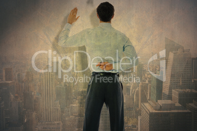 Composite image of businessman crossing fingers behind his back