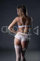 Back view of model in lingerie and garter belt