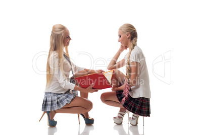 Two lovely blond schoolgirls posing in studio