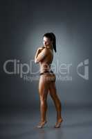 Bodybuilding. Topless woman posing back to camera