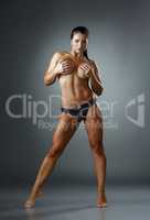 Bodybuilding. Shot of tanned woman posing topless