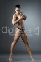 Sexual female athlete posing seminude in studio