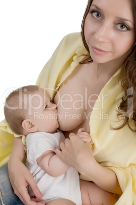 Breastfeeding. Pretty mother looking at camera