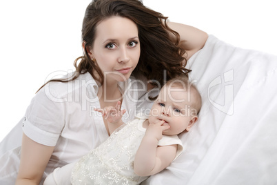 Pretty mother and her sweet baby posing in studio