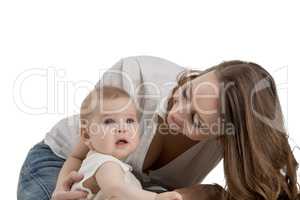 Smiling mother looking at her adorable daughter