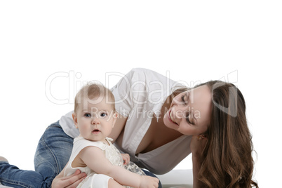 Happy dark-haired mother playing with her baby
