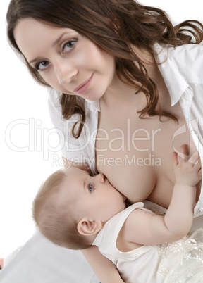 Studio photo of adorable baby during breastfeeding