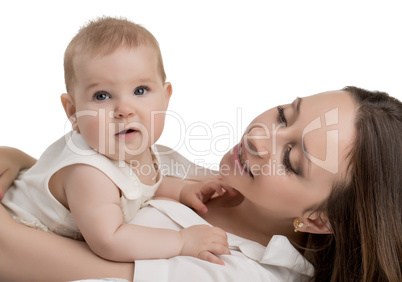 Happy young mother tenderly holding her daughter