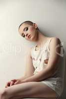 Shot of pretty skinhead girl in ragged t-shirt