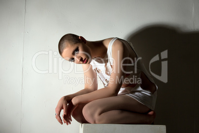 Skinhead girl posing as patient of lunatic asylum