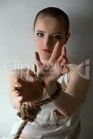 Crazy-looking girl posing with hands tied