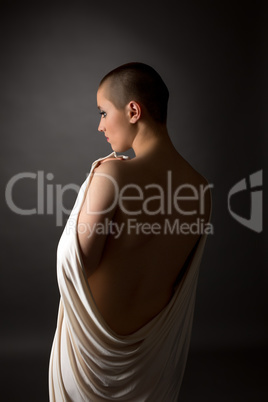 Back view of defenseless woman with shaved head