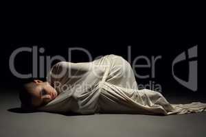Studio image of mentally ill woman in straitjacket