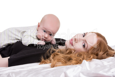 Lovely red-haired woman with baby on chest