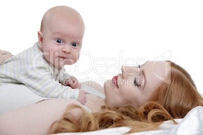 Toddler posing while lying on mother's breast