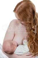 Beautiful red-haired mother nursing her child