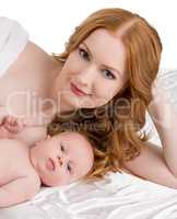 Cute redhead woman and her child posing at camera