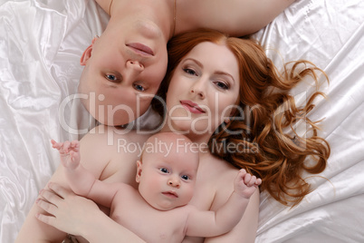 Top view of happy parents with adorable baby