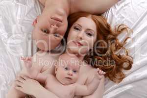 Top view of happy parents with adorable baby