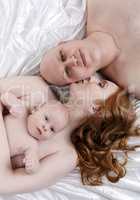 Top view of happy family having little son
