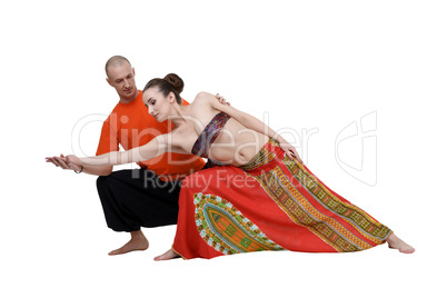Yoga. Professional coach helps to perform asana