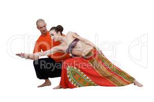 Yoga. Professional coach helps to perform asana