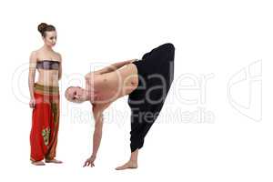Woman watches as yoga instructor performs asana
