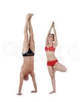Man doing handstand and woman stand on one leg