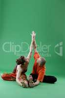 Yoga. Man and woman performing paired asana