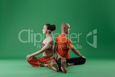 Yoga. Man and woman sitting backs to each other