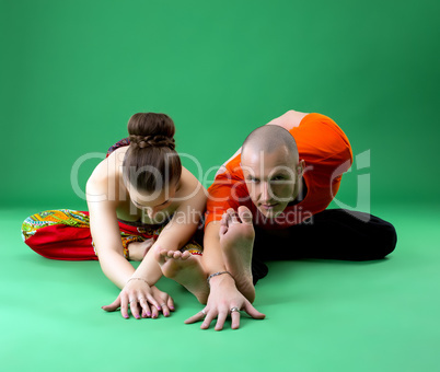 Paired yoga training. Instructor looking at camera