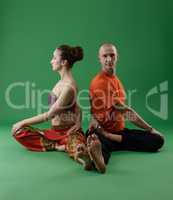 Man and woman doing yoga in pair. Studio photo
