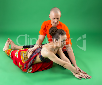 Yoga. Image of coach helps woman to perform asana