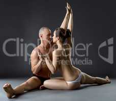 Sexual yoga. Partners posing close to each other
