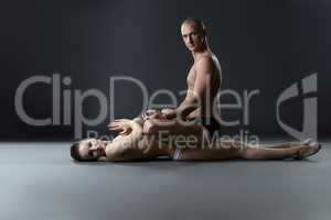 Yoga. Man sitting on nude woman in lotus position